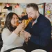 Couple feeding each other pizza