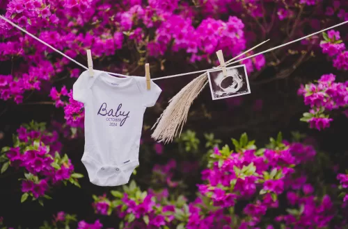 Gender Reveal decor with a baby onesie. a sonogram hung on a clothsline