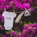 Gender Reveal decor with a baby onesie. a sonogram hung on a clothsline