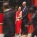 Couple holding to each other in Chinatown while blurred people are walking past them