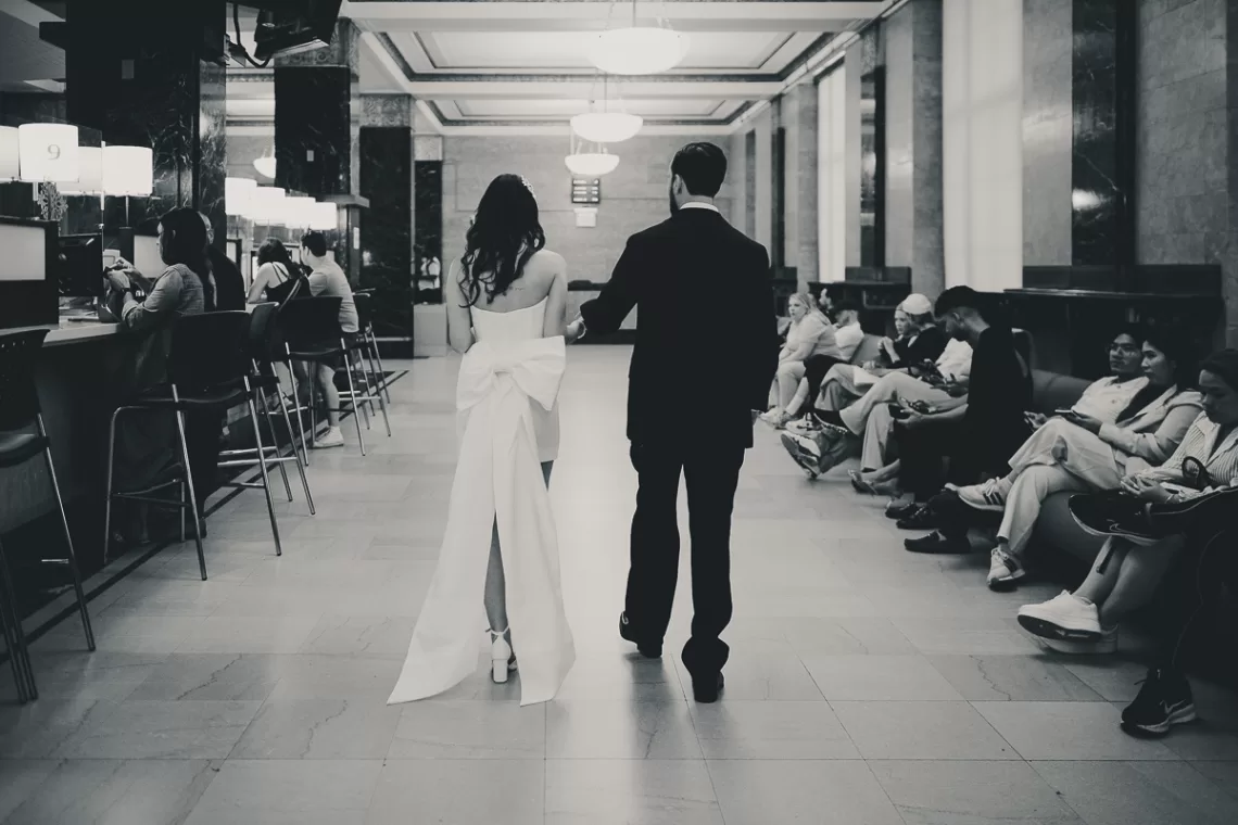 Couple leaving building from a long pathway