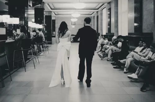 Couple leaving building from a long pathway